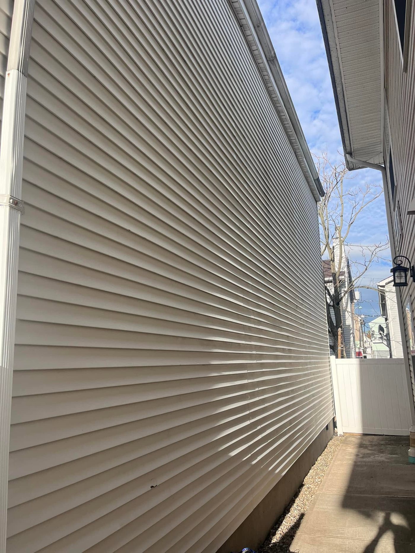 The same vinyl siding bright white after soft washing